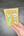 Handmade wax seal stickers in a clear package held by a hand on a gray surface