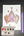 A watercolor painting of a hanging bat on white paper, shown with a purple-handled paintbrush and a small watercolor palette on a dark wood surface. The palette is labeled with colors including pyro pumpkin, poison magic mist, spirit, bat wing, and vulture moonstone.