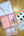 Pink paint box, sweet berry palette, and stencils on a wooden surface.