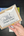 Penpal Press granulating landscape set packaging held by a hand on a dark surface