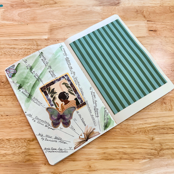 Open book with nature-themed illustrations on a wooden surface