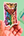 Colorful Pride Flag butterfly and flower sticker held by a hand with a green background and paint palette.