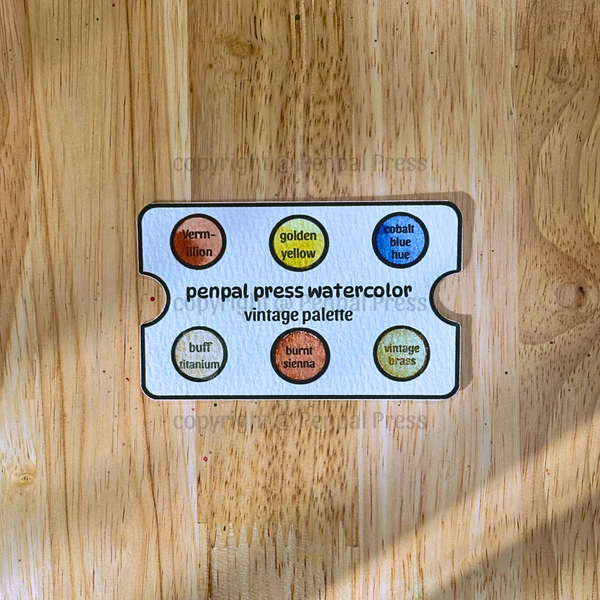 Penpal Press watercolor vintage palette on a wooden surface