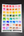 Sheet of watercolor swatches on a dark wooden surface.