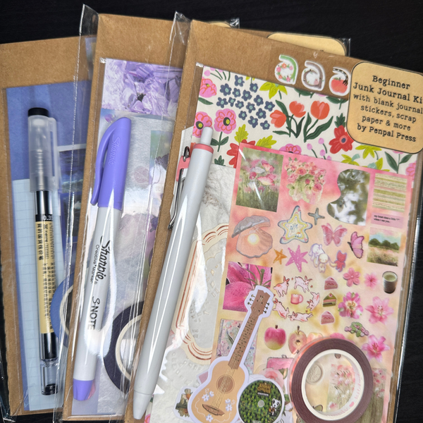 Junk journal kit with stationery items and scrapbooking materials.