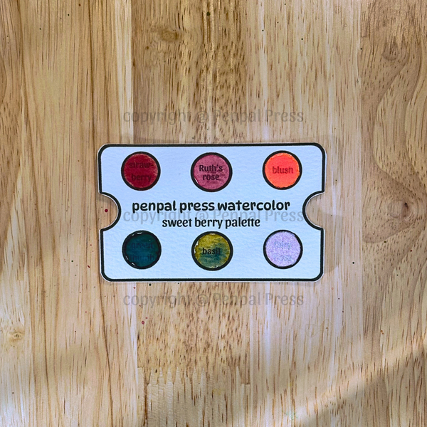Penpal Press watercolor sweet berry palette on a wooden surface