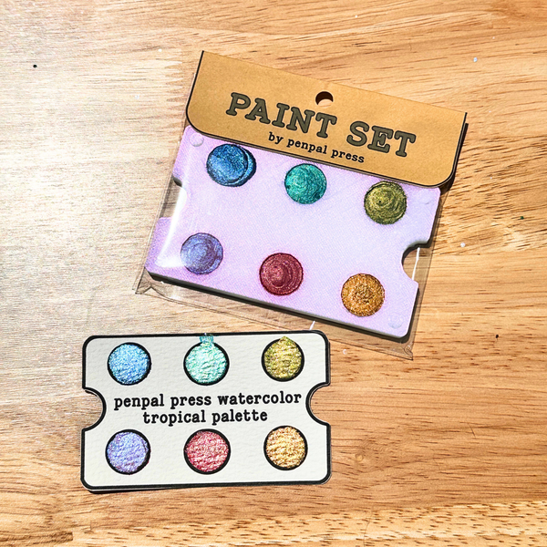 Penpal Press paint set with watercolor tropical palette on a wooden surface