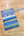 Colorful washi tape strips with patterns and text on a wooden surface.