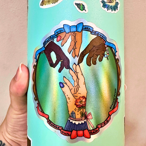 Water bottle with colorful illustration of hands holding each other, held by a hand.