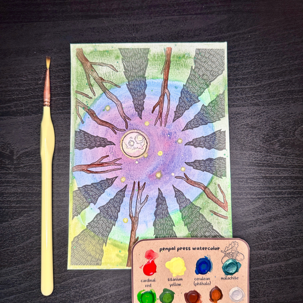 Colorful nature-themed painting with a paintbrush and color swatches on a dark surface